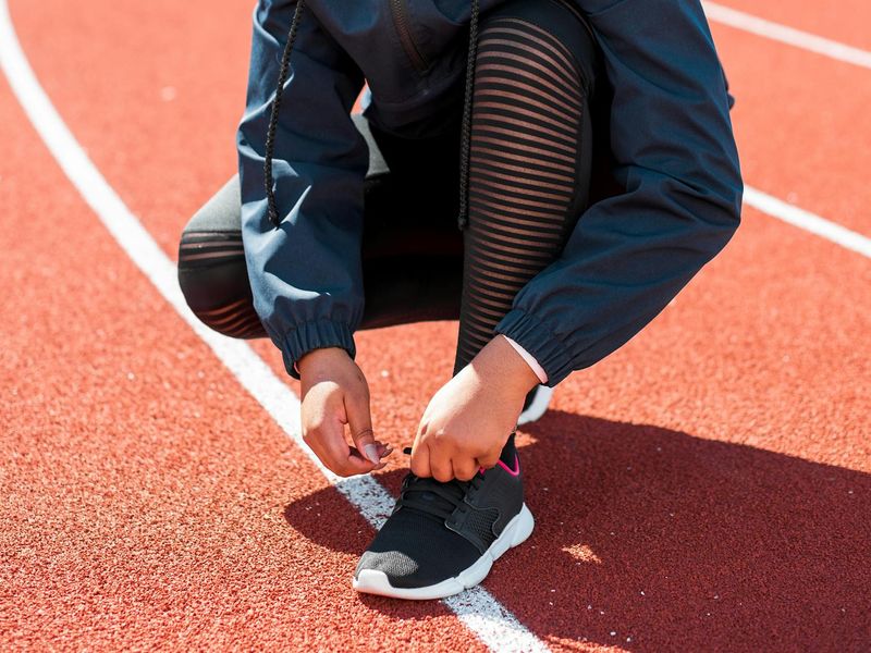 Athletic shoes on a light wooden background ready for exercise.