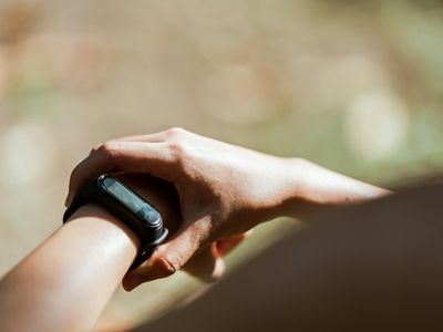 Detail of a person checking a fitness watch.