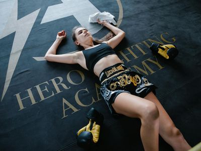Glass of water and a towel on a gym mat.